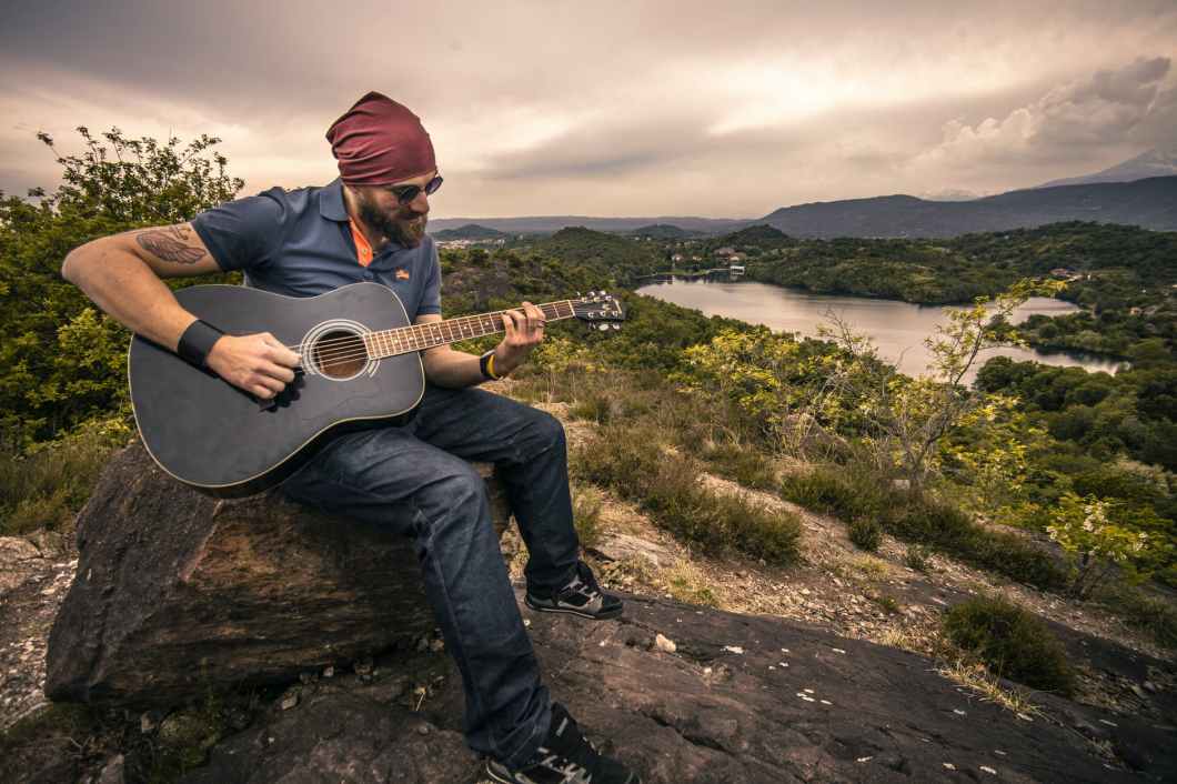 adult beard countryside guitar